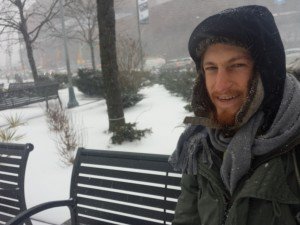 Mikey sits on a bench in the snow outside Barclays Center, Brooklyn