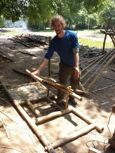 Mikey smiles as he shows off a bamboo hinged door that he built