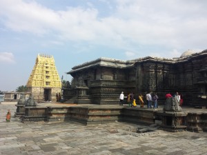 The stone edifice shown is a temple with an incredible amount of carvings on it. There are many deities and details carved into the walls.