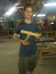 Mikey holds a bamboo joint that he made