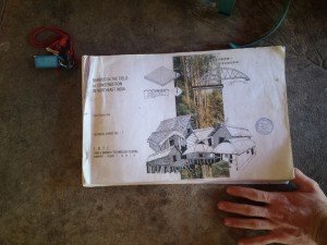 Mikey stands over a thick book titled "Bamboo In the Field of Construction in Northeast India"