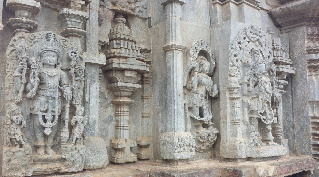 The stone edifice shown is a temple with an incredible amount of carvings on it. There are many deities and details carved into the walls.