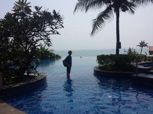 Mikey stands in an infinity pool