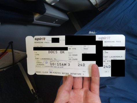 A document is shown that reads "Spirit Boarding Pass. From Lima. To Fort Lauderdale, FL. Boarding Time 10:15 AM. Depart 11:00 AM. Arrive 05:54 PM."