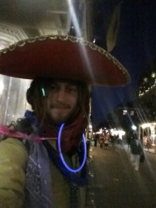 Mikey at Marti Gras in New Orleans sporting a sombreo, glostics, and colorful bandanas tied in his dreadlocks