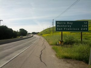 Mikey's bicycle is shown next to a sign indicating the distance to San Francisco is 249 miles