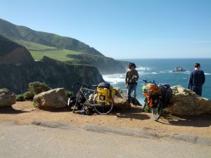 Mikey and J's bicycles are shown next to a cliff overlooking the Pacific Ocean