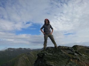 Mikey standing on a mountain in Alaska on McHugh Peak