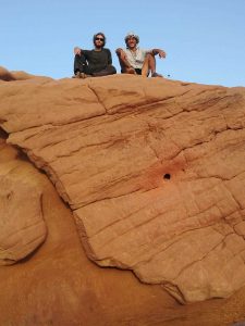 E and Mikey sit atop a sandstone rock.