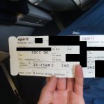 A document is shown that reads "Spirit Boarding Pass. From Lima. To Fort Lauderdale, FL. Boarding Time 10:15 AM. Depart 11:00 AM. Arrive 05:54 PM."